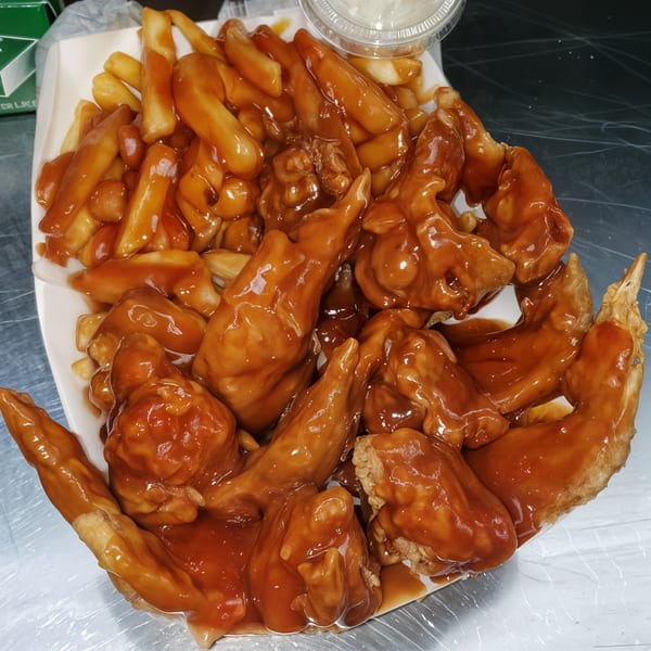 Harold's Chicken #41 fried chicken wings and fries smothered in mild sauce.